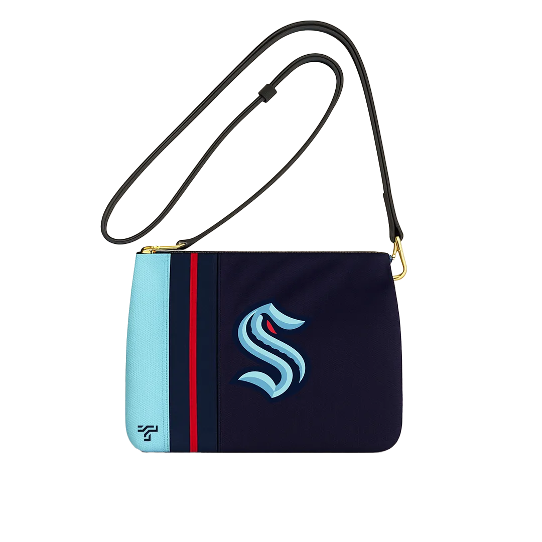 Navy crossbody bag with ice-blue and red stripes and a large Seattle Kraken S, ThreadTap mark on the corner