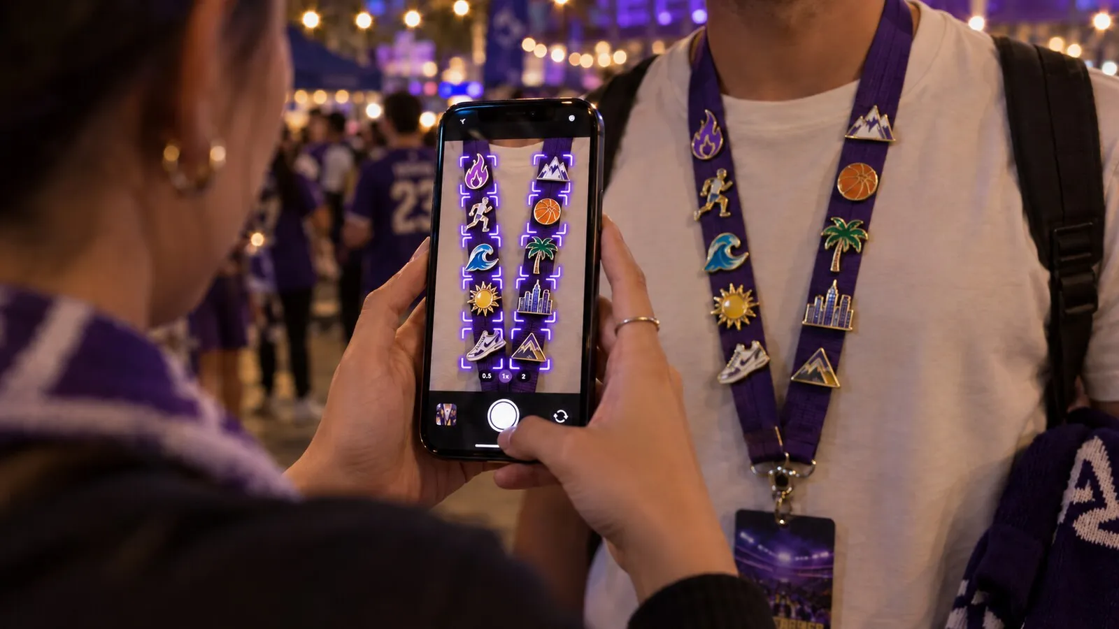 A phone camera identifying every pin on a purple lanyard, each one outlined on screen